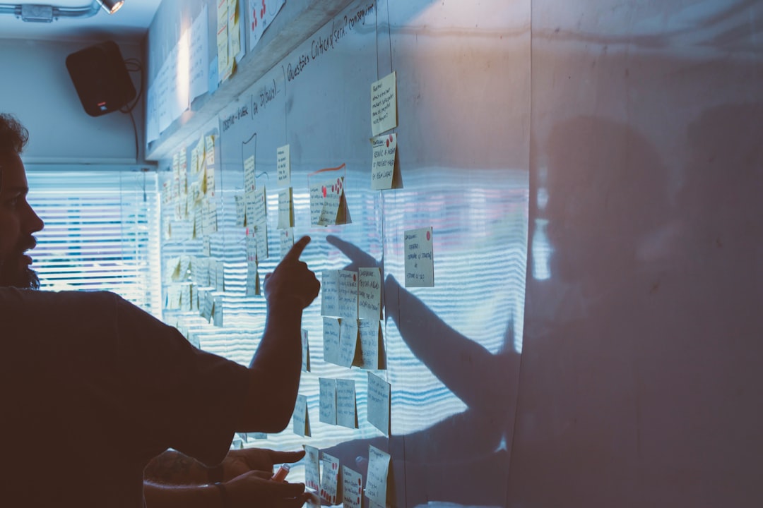 person pointing at strategy planning on whiteboard