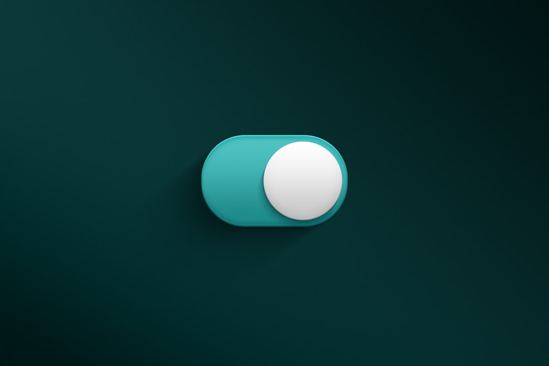 a blue and white button on a green wall