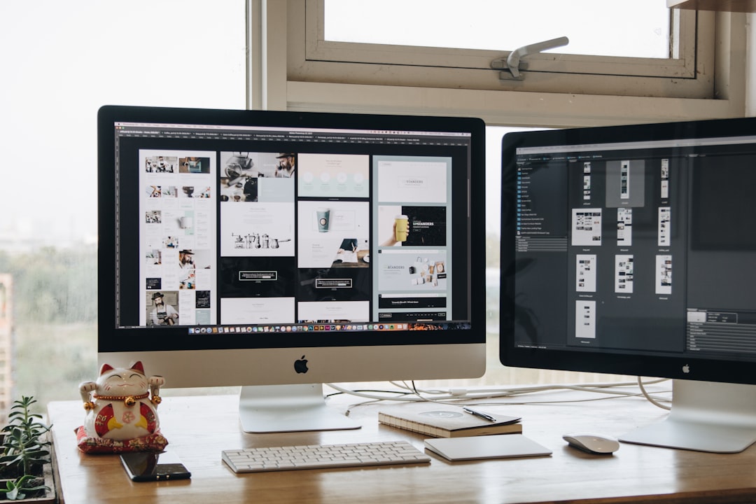 Two monitors setup next to each other on a computer desk