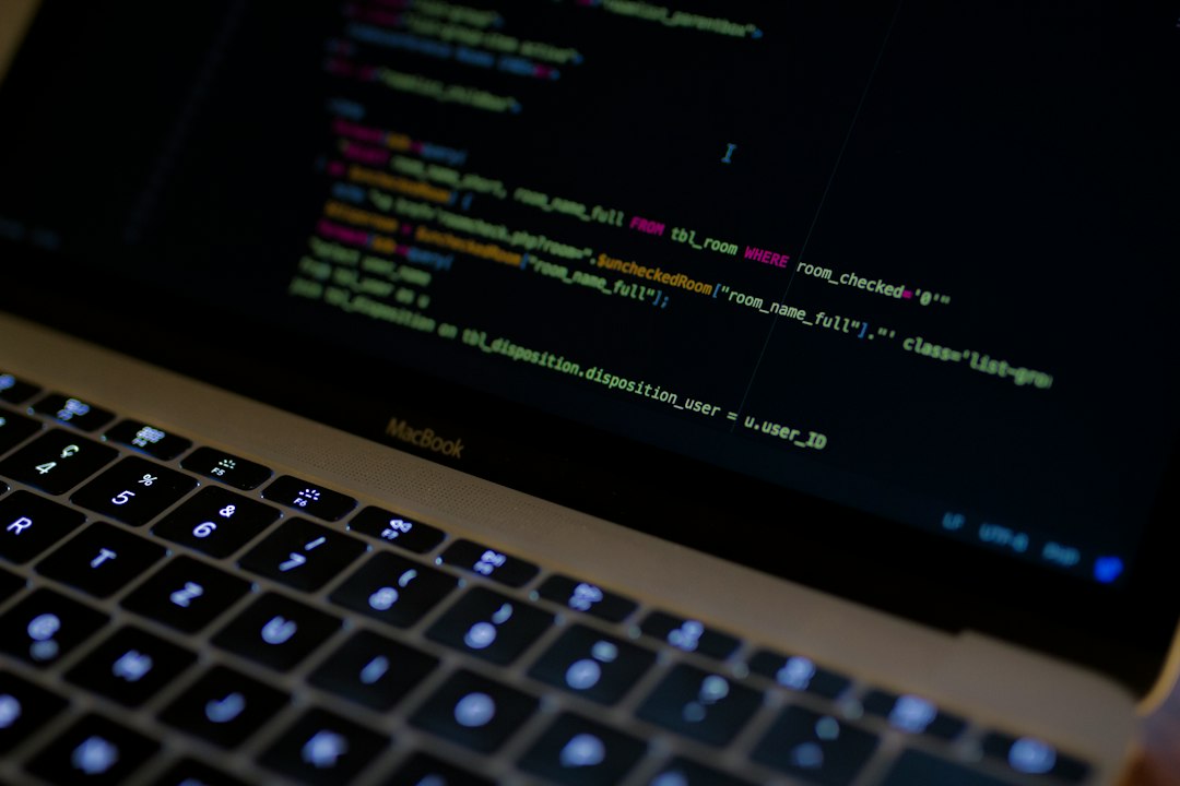 ノートパソコンでプログラムのコードを書いている手元